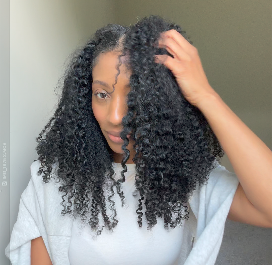 woman with natural hair braid out using melanj hair extensions for more length and volume