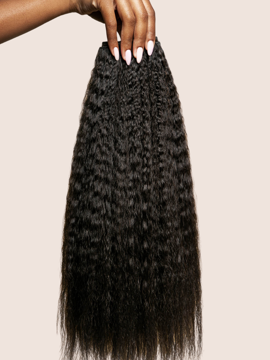 A black woman’s hand holding a bundle of loose kinky straight hair wefts by Melanj Hair