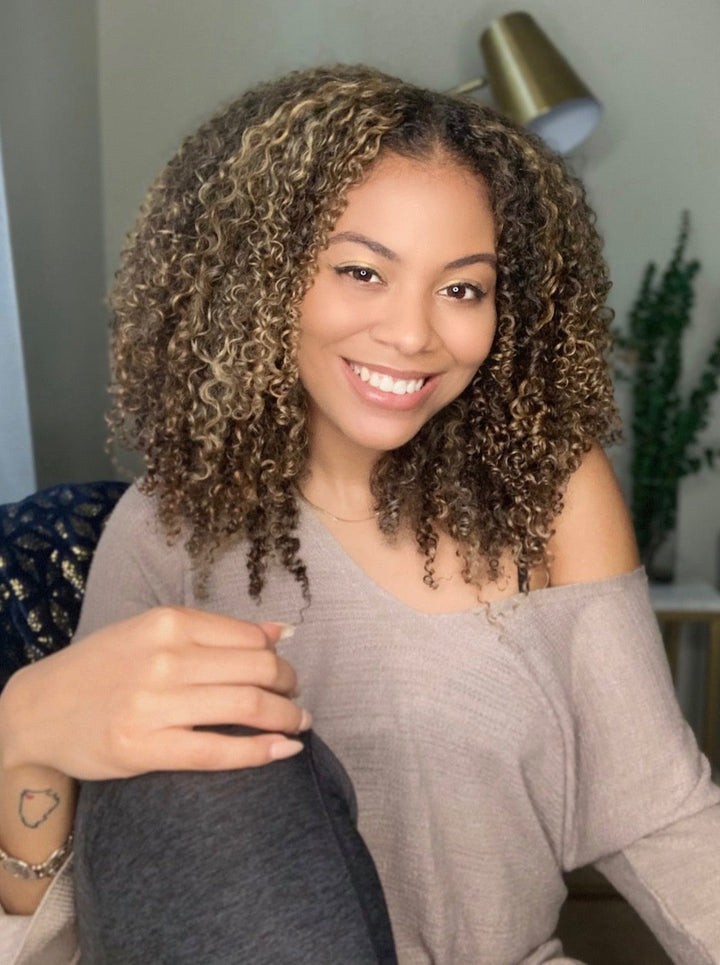 Woman wearing wash n go using blonde-colored, natural clip in hair extensions for added length and volume.