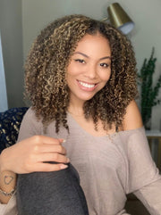 Woman wearing wash n go using blonde-colored, natural clip in hair extensions for added length and volume.