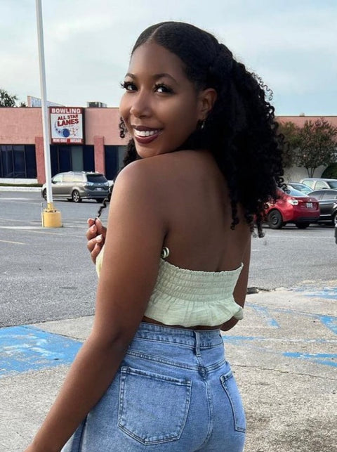 Woman wearing protective style using clip in hair extensions for type 3b/c natural textures