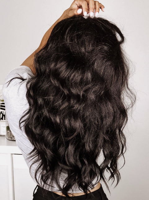 back view of loose waves on kinky straight clip-in hair extensions for Black Women by Melanj Hair