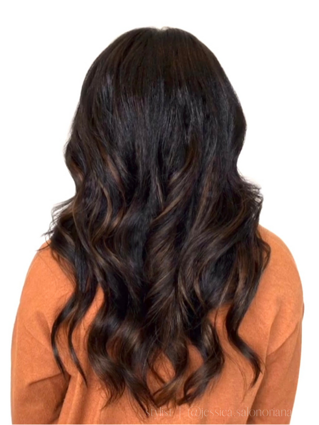 Black woman with loose wave wand curls on kinky straight, blown out hair extensions for relaxed and natural textures 