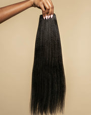 Hand holding a silk press straight bundle of Melanj hair extensions, for black women, rent hair extensions.